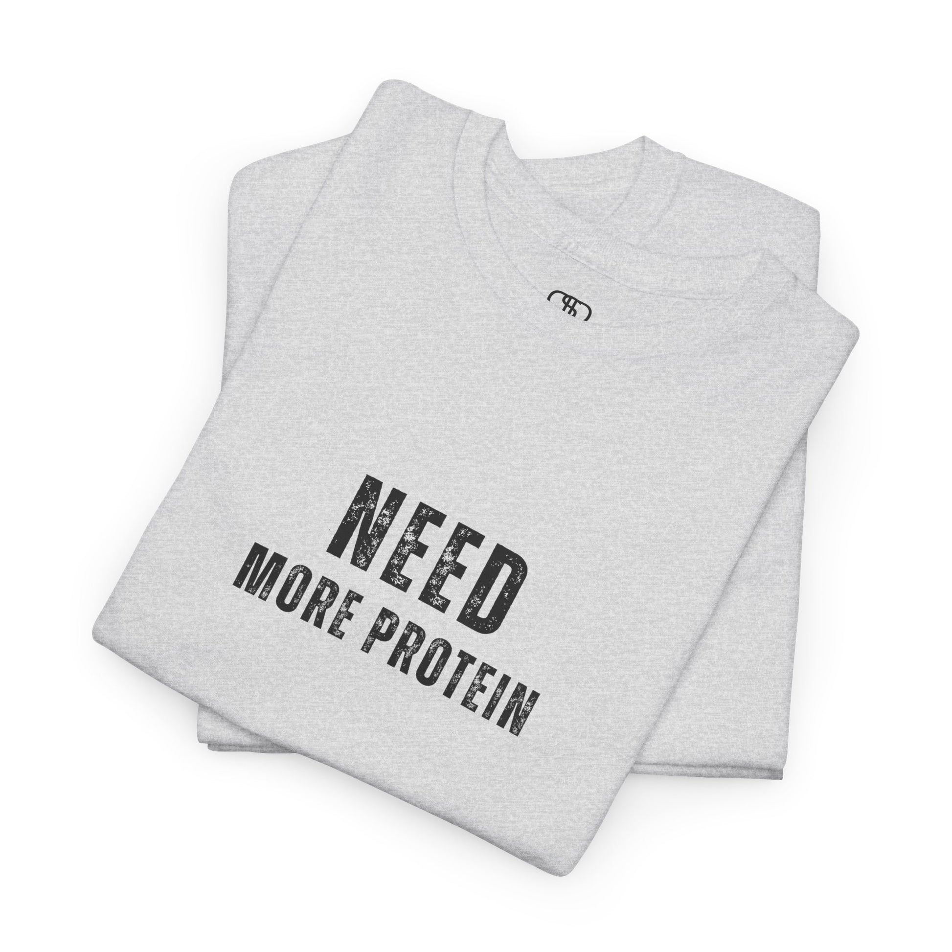 A folded ash gray t-shirt with the words “Need Protein” in a large grunge font.