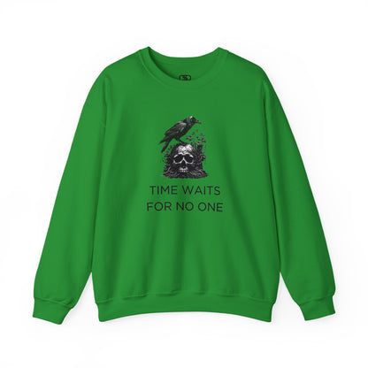 A sweatshirt featuring a detailed illustration of a crow perched on a human skull that is intertwined with overgrown vines and moss. Along with the words Time Waits For No One. 