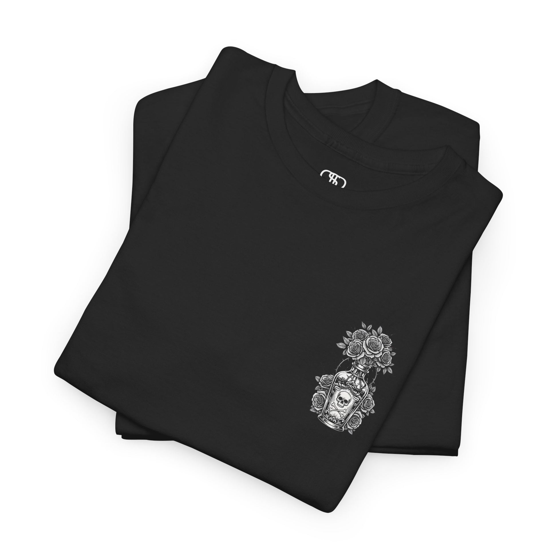 A folded black t-shirt with a skull and crossbones vase filled with roses and the words “Surviving Purely Out of Spite” in a gothic font.