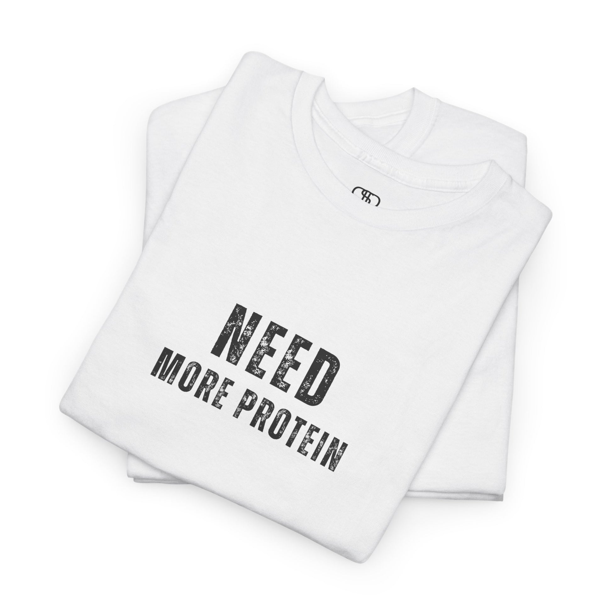 A folded white t-shirt with the words “Need Protein” in a large grunge font.