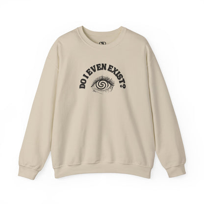 A sand sweatshirt with a graphic print of a detailed, realistic eye that contains an optical illusion of a spiral. The text "Do I even Exist?" is printed below the eye in a clean, sans-serif font.