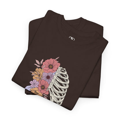 Folded T-shirt with a lung graphic, half skeletal ribcage, half flowers.
