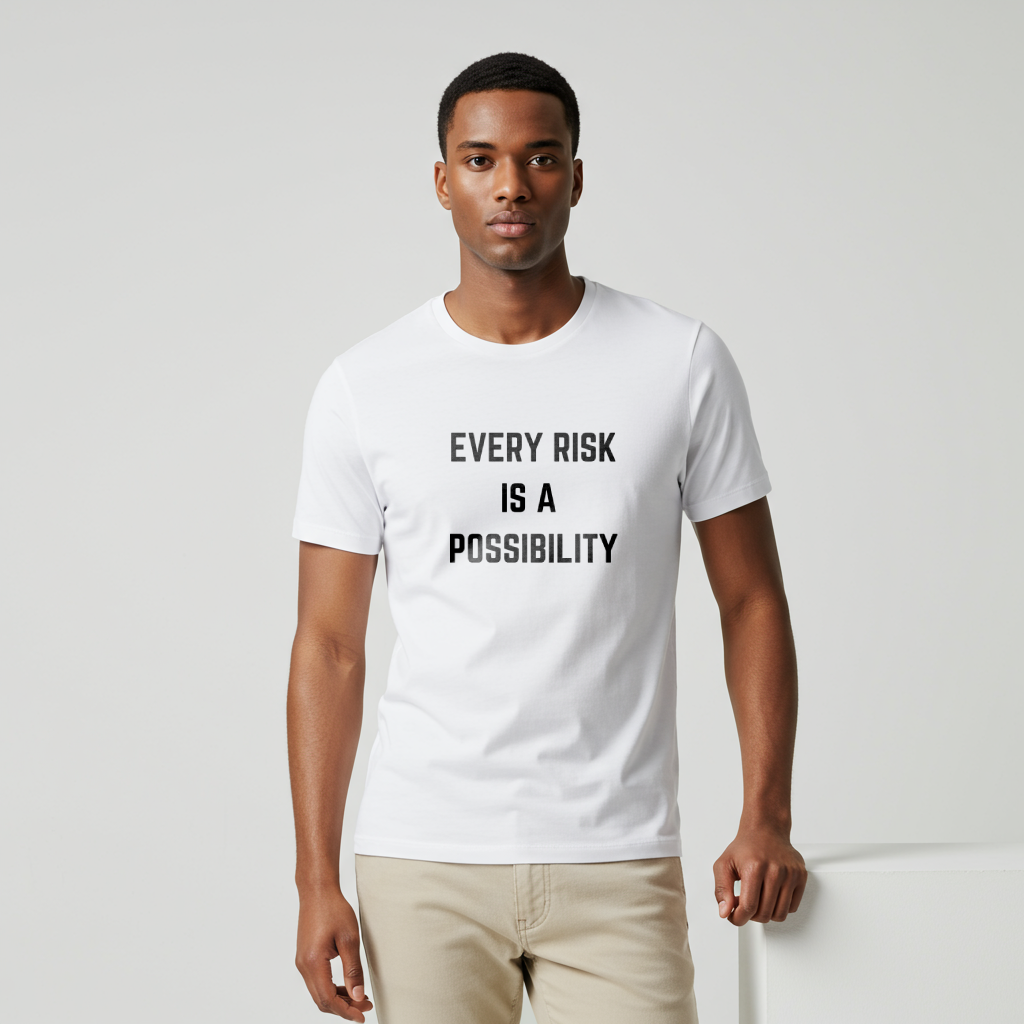A male model wearing  a t-shirt featuring the motivational quote "Every Risk Is a Possibility." in a clean, bold font.